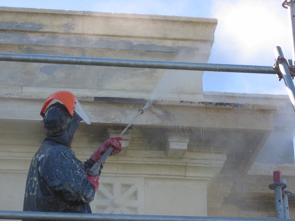 The cap/parapet on the building which is oamaru stone was tarred, fibreglassed and painted 20 years ago to stop moisture penetration.The cap had sealed all the moisture in the oamaru stone creating very bad effervescence on the walls and ceilings with water dripping on the inside. JetX stripped the fibreglass off by hand and then using our restoration techniques pulled the tar out of the stone without damage to the substrate.